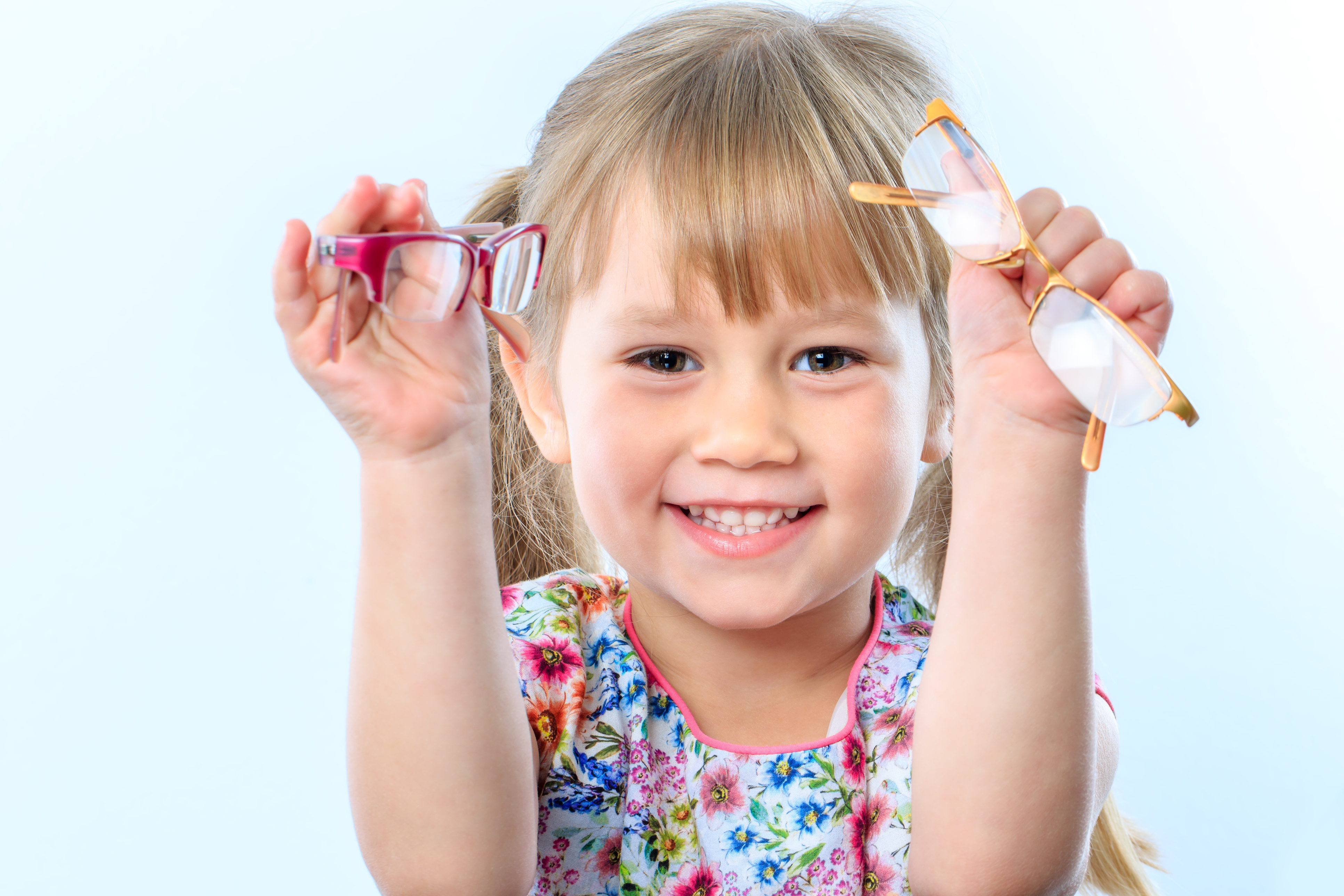 Little girl holding eyeglasses