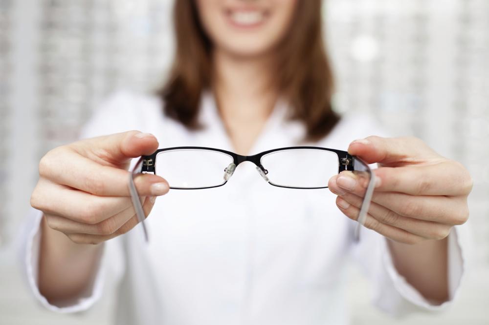 Maple Ridge optometrist holding a pair of glasses
