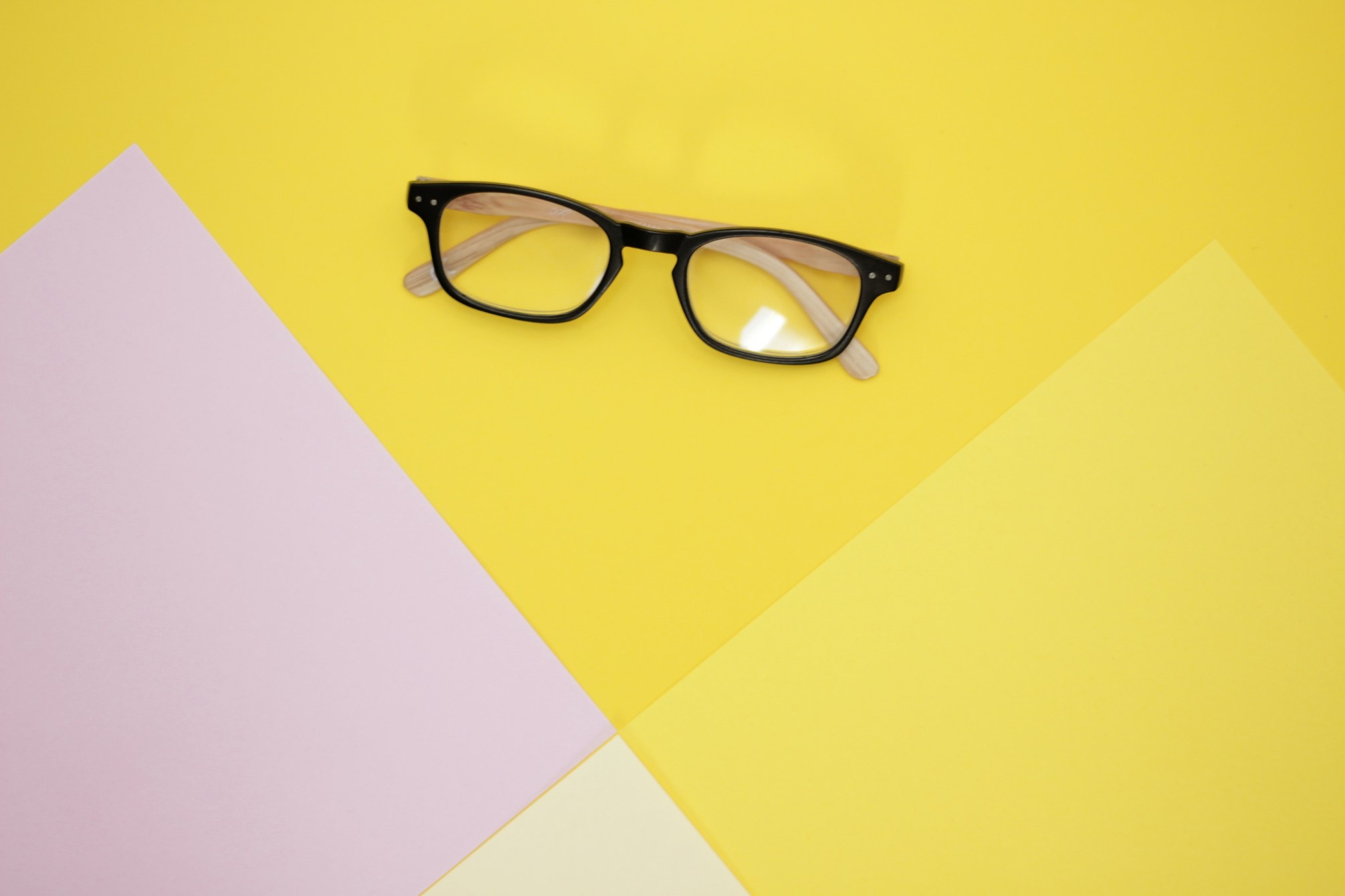 Black Frame Glasses on Yellow Backdrop