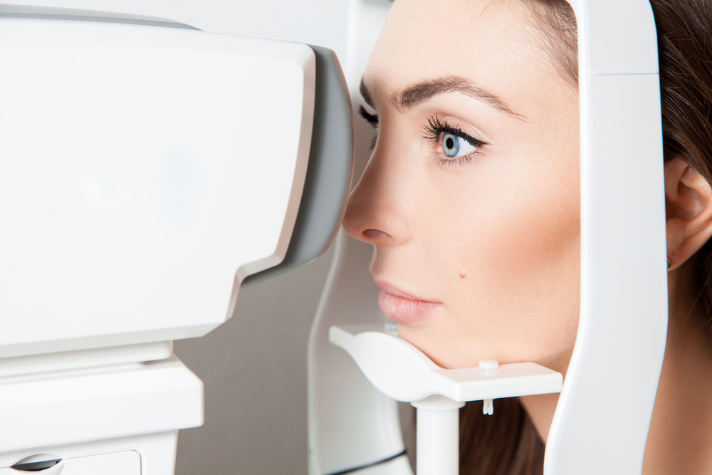 woman getting OPTOS retinal exam