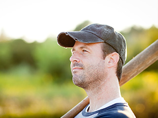 A Man In A Ball Cap Holding A Baseball Bat - Sports Vision Pensacola - Fifty Dollar Eye Guy 5328 N Davis Hwy Pensacola, FL 32503 (850) 434-6387