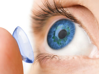 A Person Putting A Contact Lens In Their Blue Eye- Contact Lens Exam Pensacola- Fifty Dollar Eye Guy 5328 N Davis Hwy Pensacola, FL 32503 (850) 434-6387