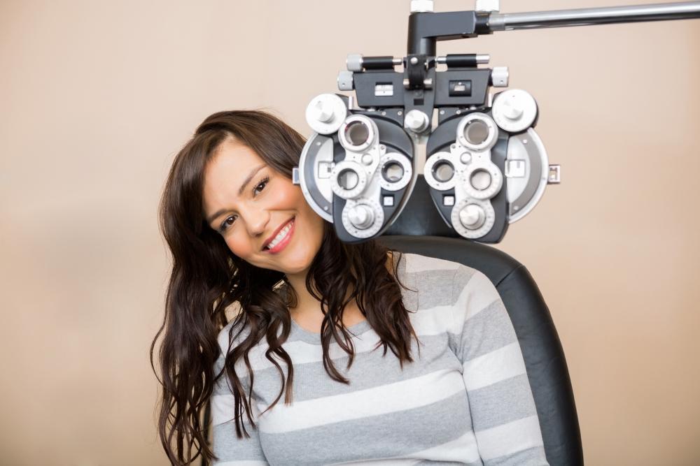Woman receiving eye exam with Birmingham optometrist