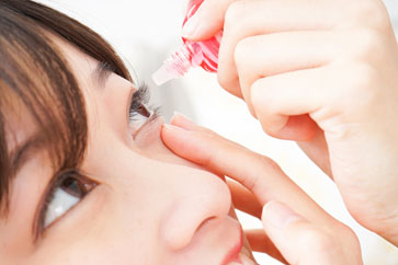 Girl adding eye drops