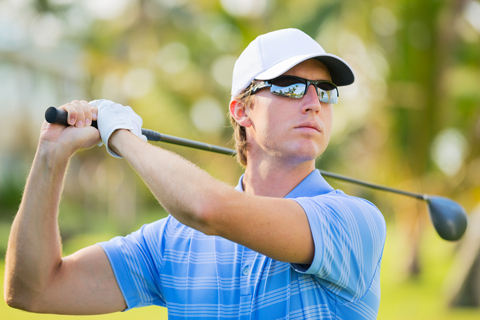 Man with golf club and sunglasses